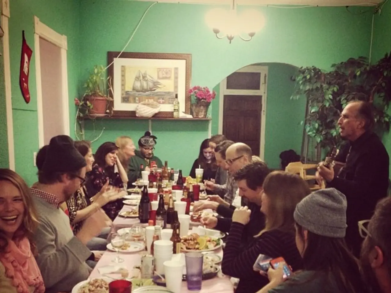 The picture looks like it is a dining hall,there is a big table and there are many food items kept...