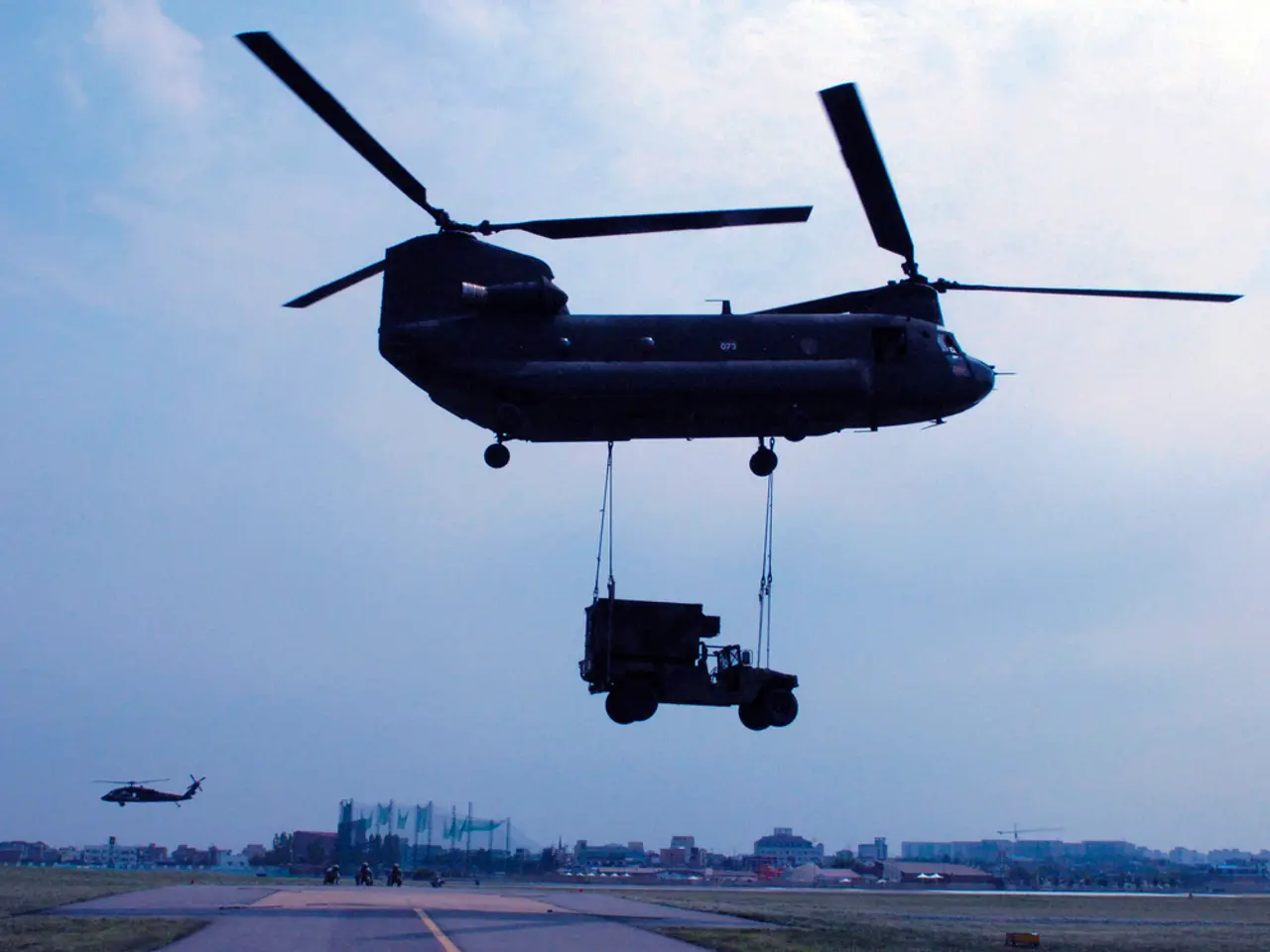 There is an aircraft. Which is lifting a jeep with the help of threads. Below this, there is a...