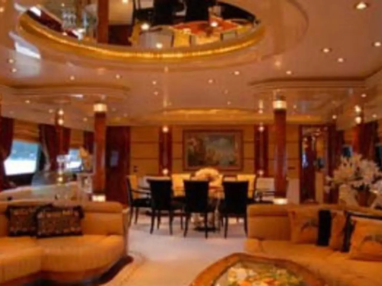 This is a picture of a hotel. In the foreground of the picture there are couches, pillows, chairs,...