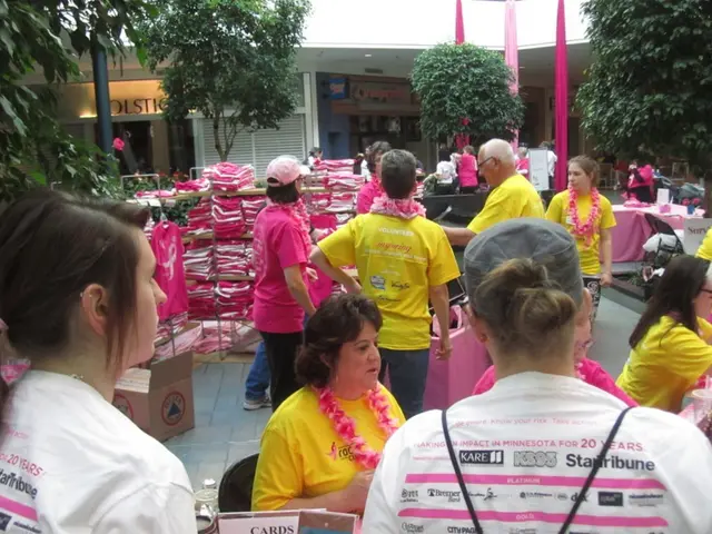 In this image I can see few people with yellow, pink and white color dresses. I can see one person...