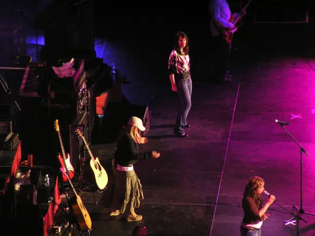A group of people are performing on stage. Of them,three are women and a man.