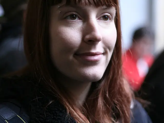 In this image we can see a woman smiling.