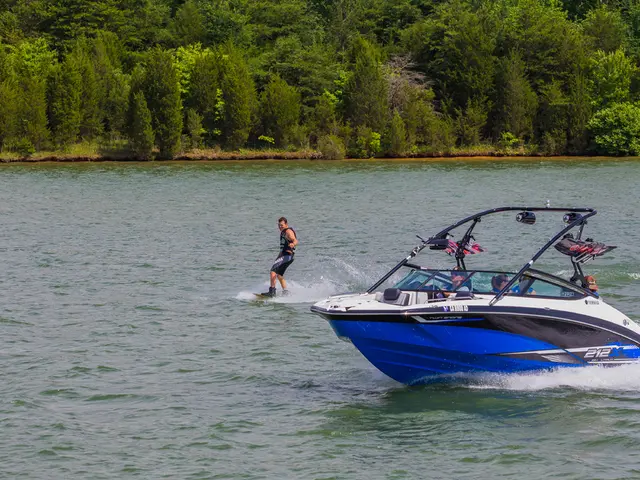 In this picture I can see few people seated in the boat and a man is wake surfing in the water and...
