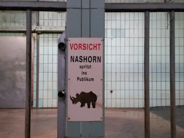 In this picture there is a sign board and a net in the center of the image.