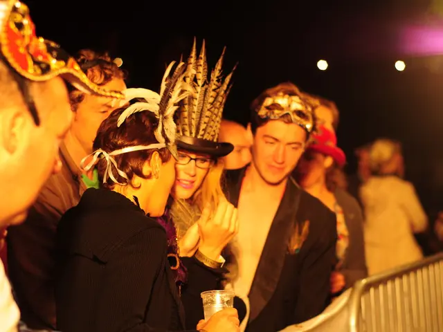 In this picture we can see there are groups of people with the masks and in front of the people...