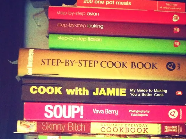 In this image I see number of books on which there is something written and I see that it is dark...