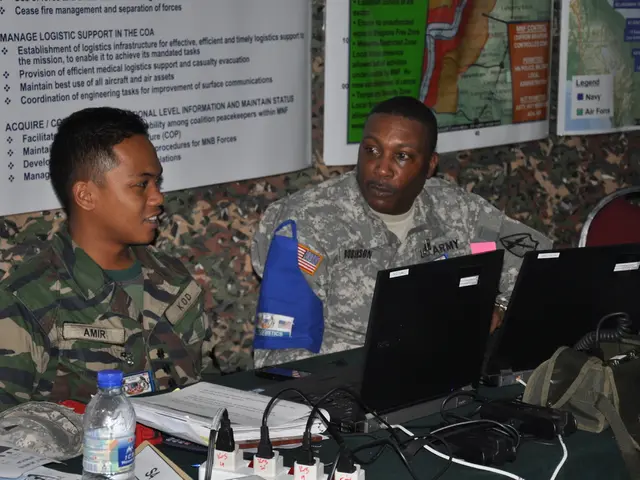 This picture is clicked inside. In the foreground there is a table on the top of which papers,...