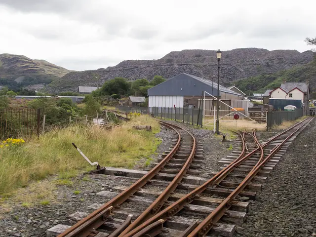 There are railway tracks. On the railway tracks there are stones. On the left side there are...