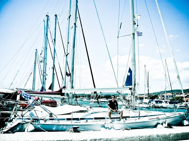 In this image we can see ships on the water. In the center there is a man sitting in the ship. On...